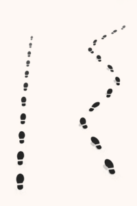 Minimalist illustration of footprints that start in a straight line and gradually drift to the side, symbolizing slow ethical drift in decision-making.